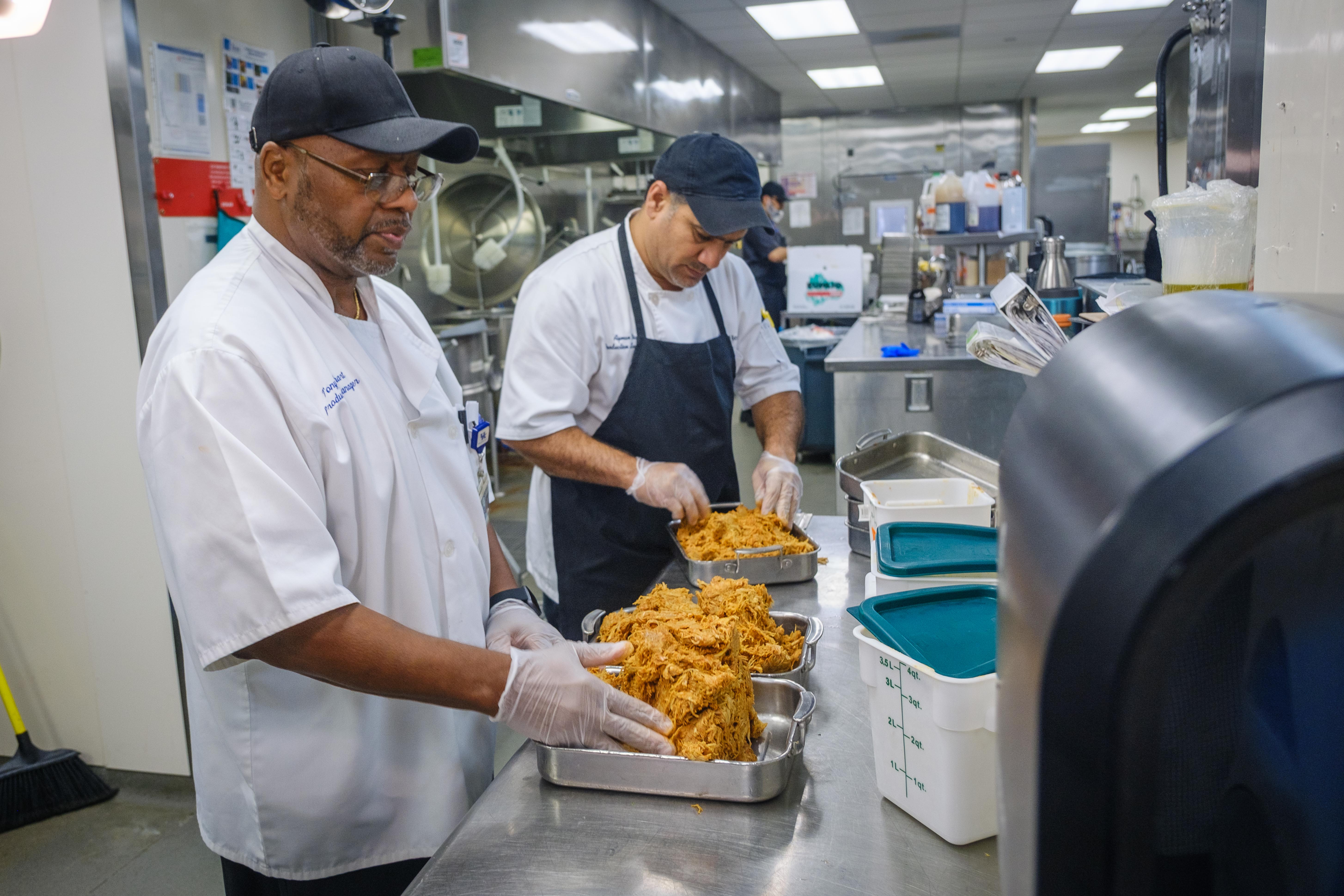 Members of UK Healthcare food services package extra food in special containers for the Meals on Wings program