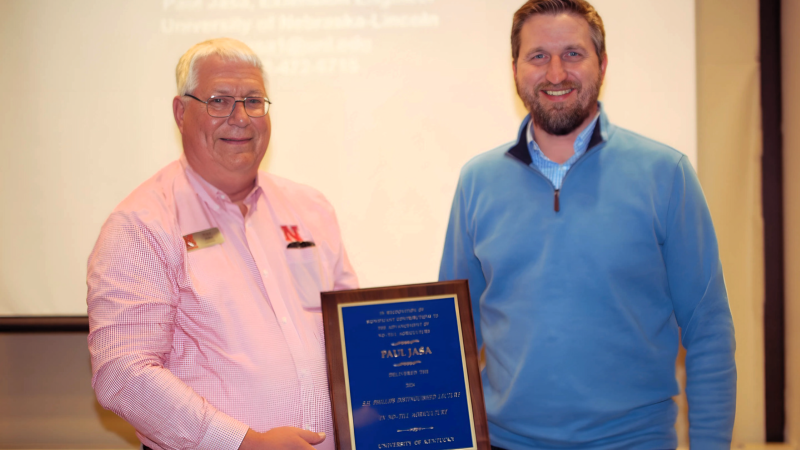 Paul Jasa (pictured left) receiving the 2024 Shirley Philips No-Till award from Chad Lee (pictured right). 